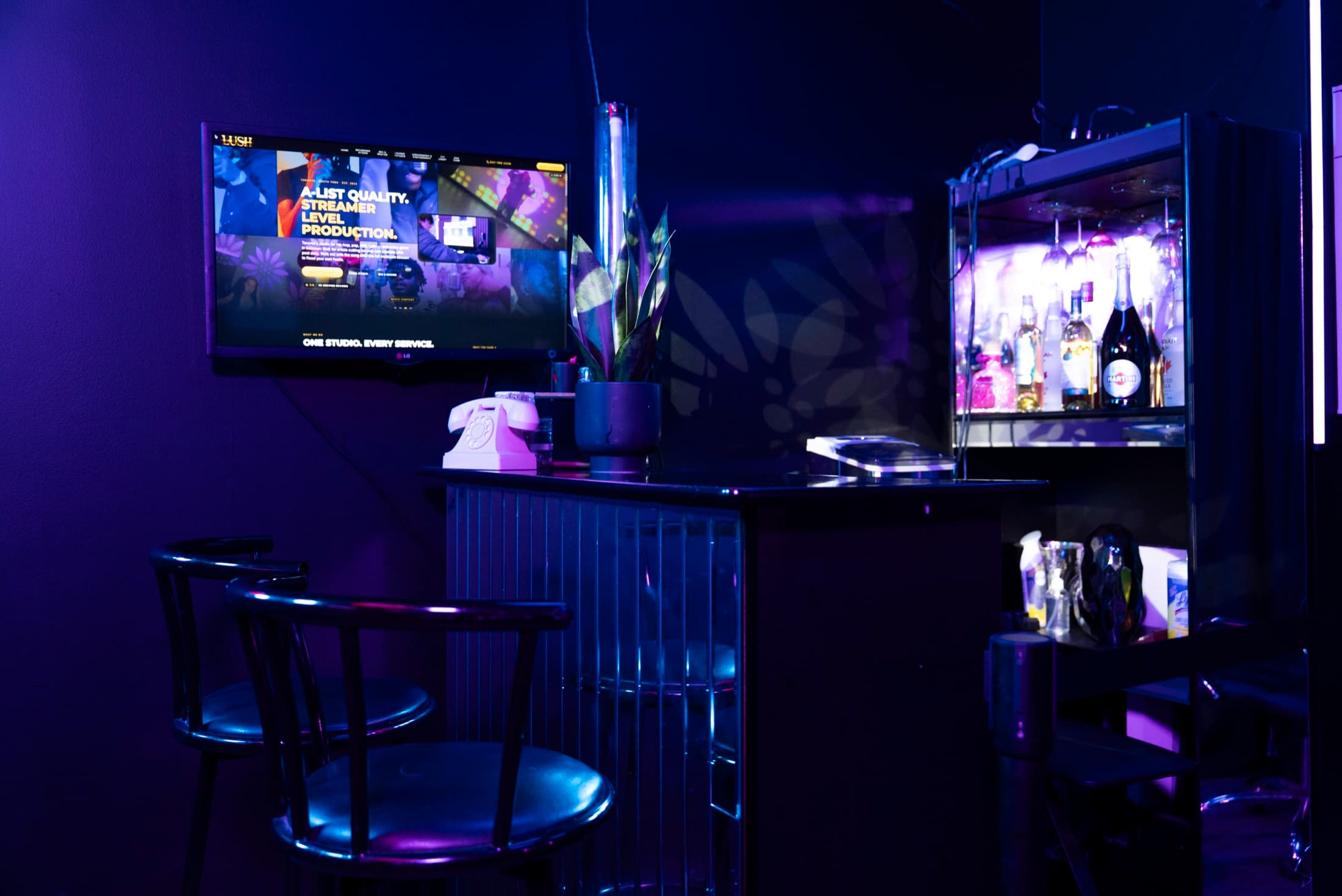 The bar with backlit bottle display in blue-purple light